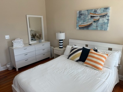 Sleep peacefully in your bright, modern bedroom with fresh linens and nautical touches that create a calming coastal retreat.