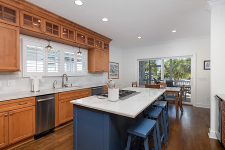 Your dream coastal kitchen awaits with warm cabinetry, a spacious island for morning coffee, and gleaming countertops perfect for preparing fresh seafood dinners together.