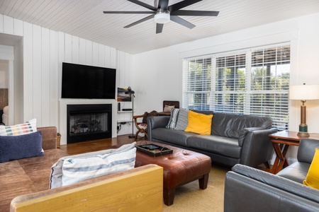 Settle into your comfortable living room with a cozy fireplace and large windows