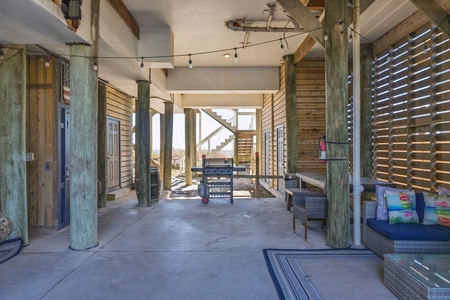 Located beneath the house is additional parking space and a grill for cookouts