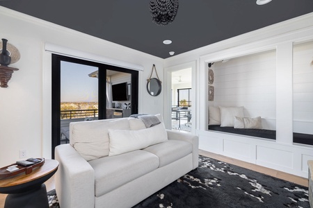 Unwind in your cozy reading nook with built-in seating and stunning views through floor-to-ceiling windows.