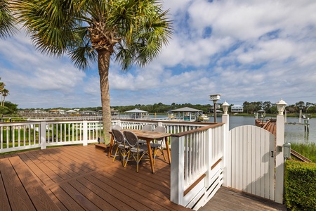Your private waterfront deck invites lazy afternoons beneath swaying palms, where morning coffee and sunset dinners come with serene marina views and gentle coastal breezes.