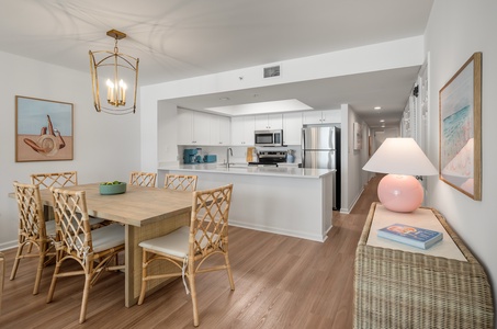 Gather around your stylish dining table where coastal charm meets modern comfort in this bright, open-concept space.