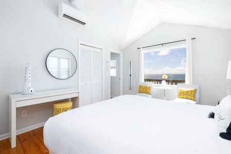 Wake up to the gentle sound of waves and a stunning ocean view framing your serene retreat. The crisp white linens and cool sea breezes promise the perfect start to your day.