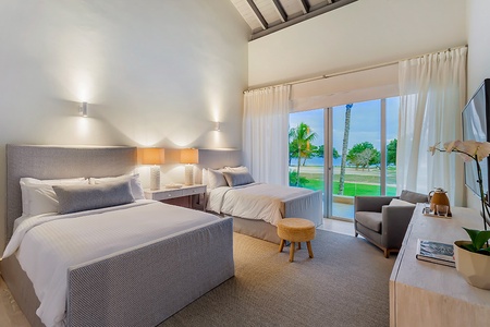 The guest bedroom offers two queen beds and private patio.