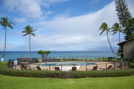 From the lanai, the view stretches past the pool and out over the ocean to the island on the horizon.