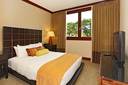 The second guest bedroom with a queen bed and views.