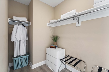 Spacious walk-in closet includes plush guest robes and plenty of storage space.