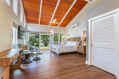The Lani Oasis primary suite offers a king bed, vaulted ceilings, and direct access to the garden and poolside views.