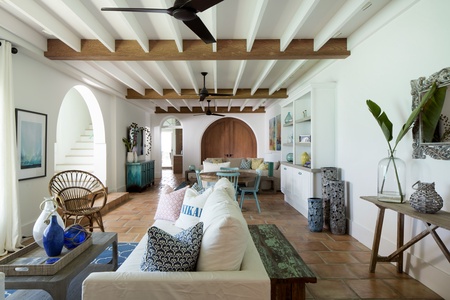 The breezy living space with elegant beams and coastal-inspired decor.