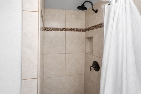 Walk-in tiled shower in the primary ensuite—spa-inspired and ideal for relaxing after a day exploring Kona.