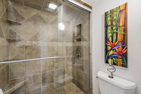 Experience a spa-like walk-in shower at Papakea L-106, with modern fixtures and a glass enclosure