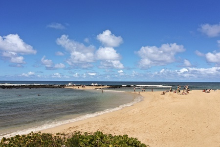 Enjoy endless stretches of golden sand and refreshing ocean breezes at Poipu Beach Park.