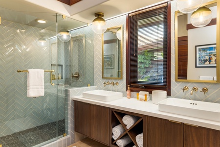 Glass walk-in shower, floating vanity, and clean lines define this modern, guest-friendly bath.