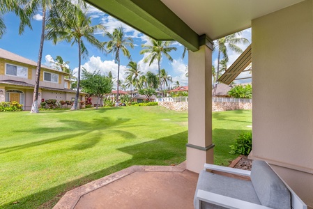 Scenic view from the lanai, showcasing lush greenery and palm trees for a true island paradise experience.