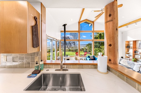 Let the view do the seasoning—this bright kitchen sink setup offers stunning ocean backdrops with every rinse and prep.