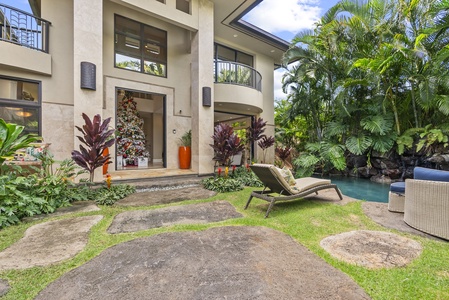 Grand entrance surrounded by tropical landscaping.