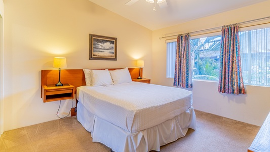 The primary guest bedroom is comfortable and spacious for a restful slumber.