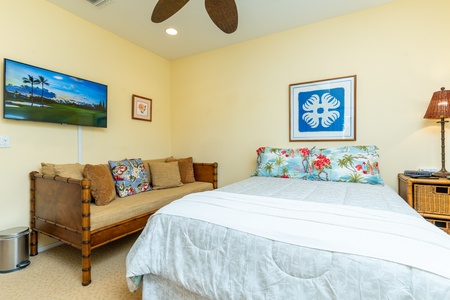 This cozy ground-floor bedroom includes a queen-size bed, ceiling fan, and nearby private lanai—ideal for guests seeking easy access.