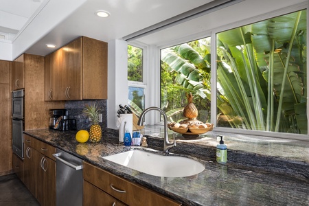 Wash dishes while taking in the lush landscaping surrounding the property
