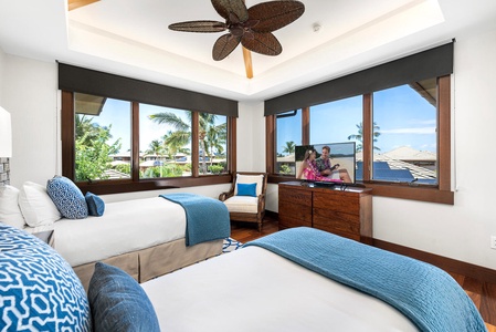Spacious twin suite ideal for kids or guests, complete with seating nook.