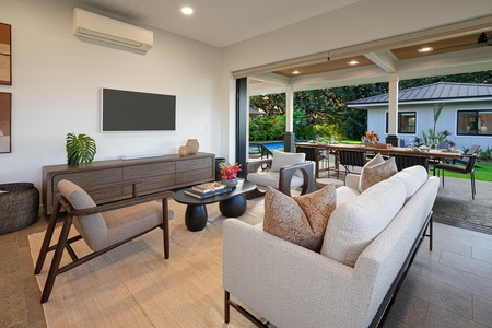 Stylish living space with natural light and lush garden views.