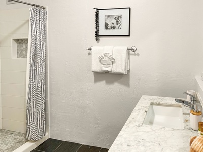 Hall bath with modern fixtures, conveniently located near bedroom three.