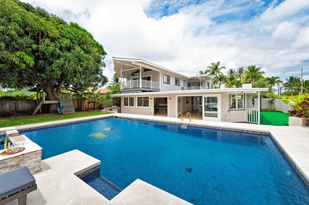 Lush backyard with large pool deck and pool give you all the feels of having your own private mini hotel!  (Note: Upper pool area is apart of the pool and NOT a spa)