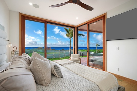 The primary suite with TV, large windows and direct access to the lanai.