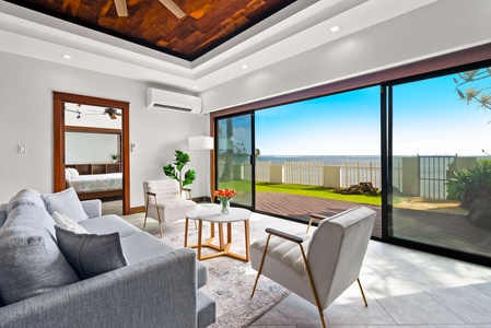 Lounge area with modern furnishings and garden views, ideal for relaxation.