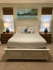 Guest bedroom with queen bed and soft coastal tones — a serene space for restful nights.