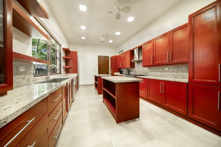 The fully-stocked kitchen has wide counter spaces and stainless steel appliances.