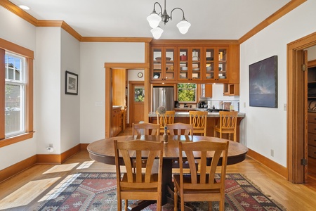 Dining table seats up to four with extra seating to the adjacent kitchen bar/island