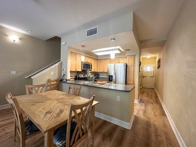 Dining area with seating for six, ideal for home-cooked meals or takeout from nearby restaurants.