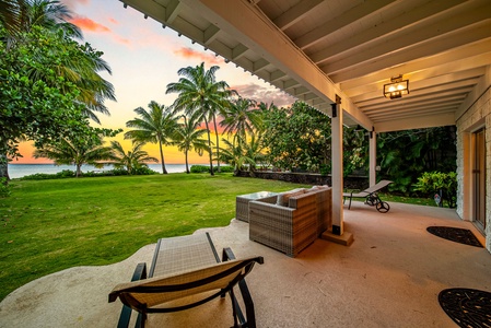 Backyard framed by lush palms and glowing sunset skies.
