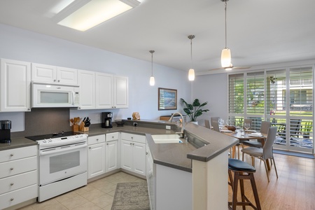A bright kitchen with numerous amenities including a wine fridge.