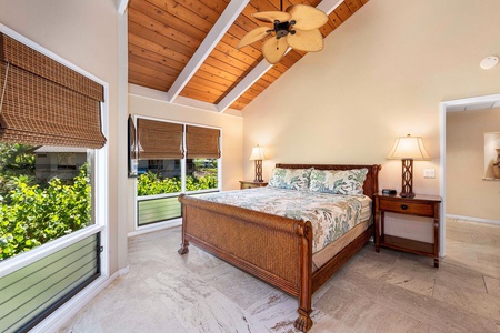 The primary suite offers a peaceful retreat with vaulted ceilings, a king bed, and tranquil garden views.