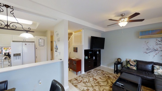 The open floor plan with a TV and storage space.