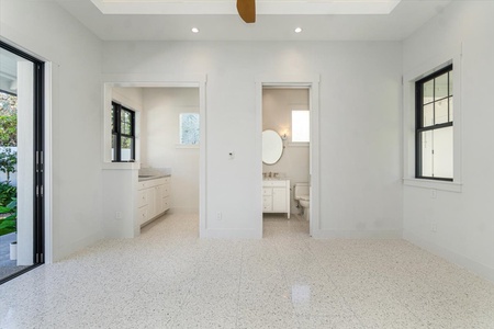 Expansive bath with dual access and abundant natural light.