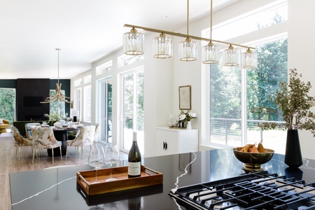 The gourmet kitchen blends elegant finishes, premium appliances, and expansive windows, creating a bright and inviting space for cooking, entertaining, and gathering together.