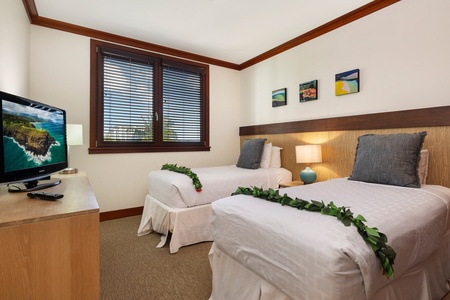 Your comfortable twin bedroom features modern amenities and tropical touches, creating the perfect retreat after island adventures.