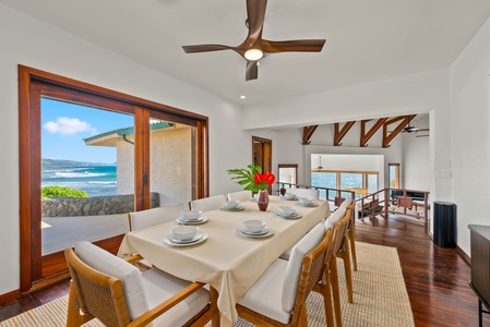 Unwind in your stunning oceanfront living room where soaring ceilings and panoramic windows frame endless sea views while you relax by the stone fireplace.