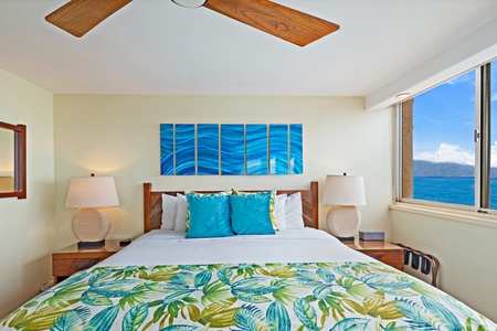 Royal Kahana 610's primary bedroom offers a plush king-sized bed with tropical accents, perfect for a restful night's sleep.