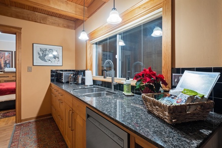 Holiday-ready kitchen with generous counter space and views of lush evergreens.