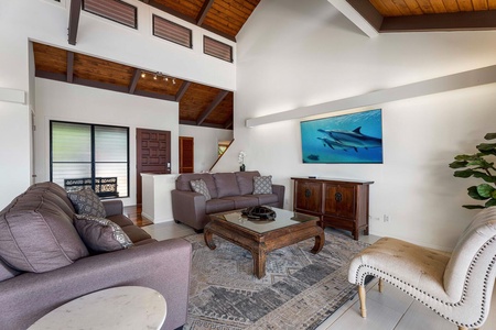 Lounge in the living area with high ceilings and a large TV.