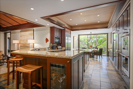 Custom carved wood paneling and seating greet guests in this artfully designed foyer space.