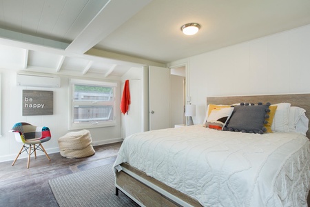 Bright and inviting guest bedroom with serene views and plenty of space to unpack and unwind.