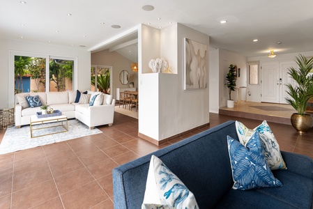 Walk into the open space with formal dining room and two living areas open to the pool area