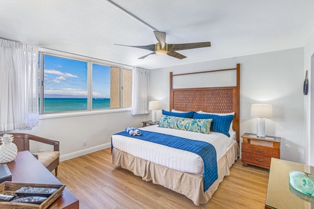 Spacious primary bedroom with ocean views and a comfortable king bed, offering a peaceful retreat after a day of exploring.