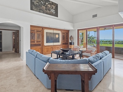 Unwind in your elegant living room with plush seating and stunning views through floor-to-ceiling windows.